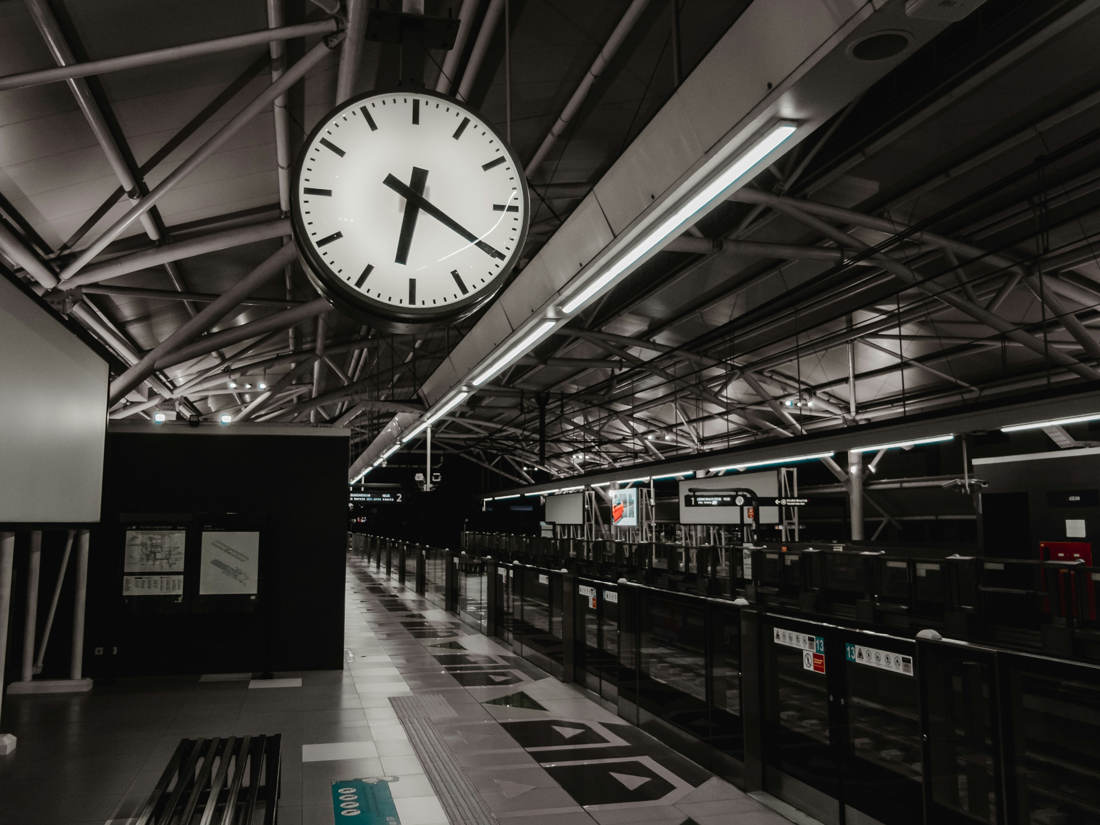 a large clock hanging from the ceiling of a building