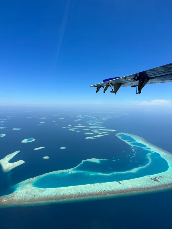 Seaplane flying over an island in the Maldives