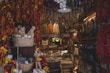 Selection of cured sausages and salamis hanging on a wooden rack in a traditional Chilean countryside setting