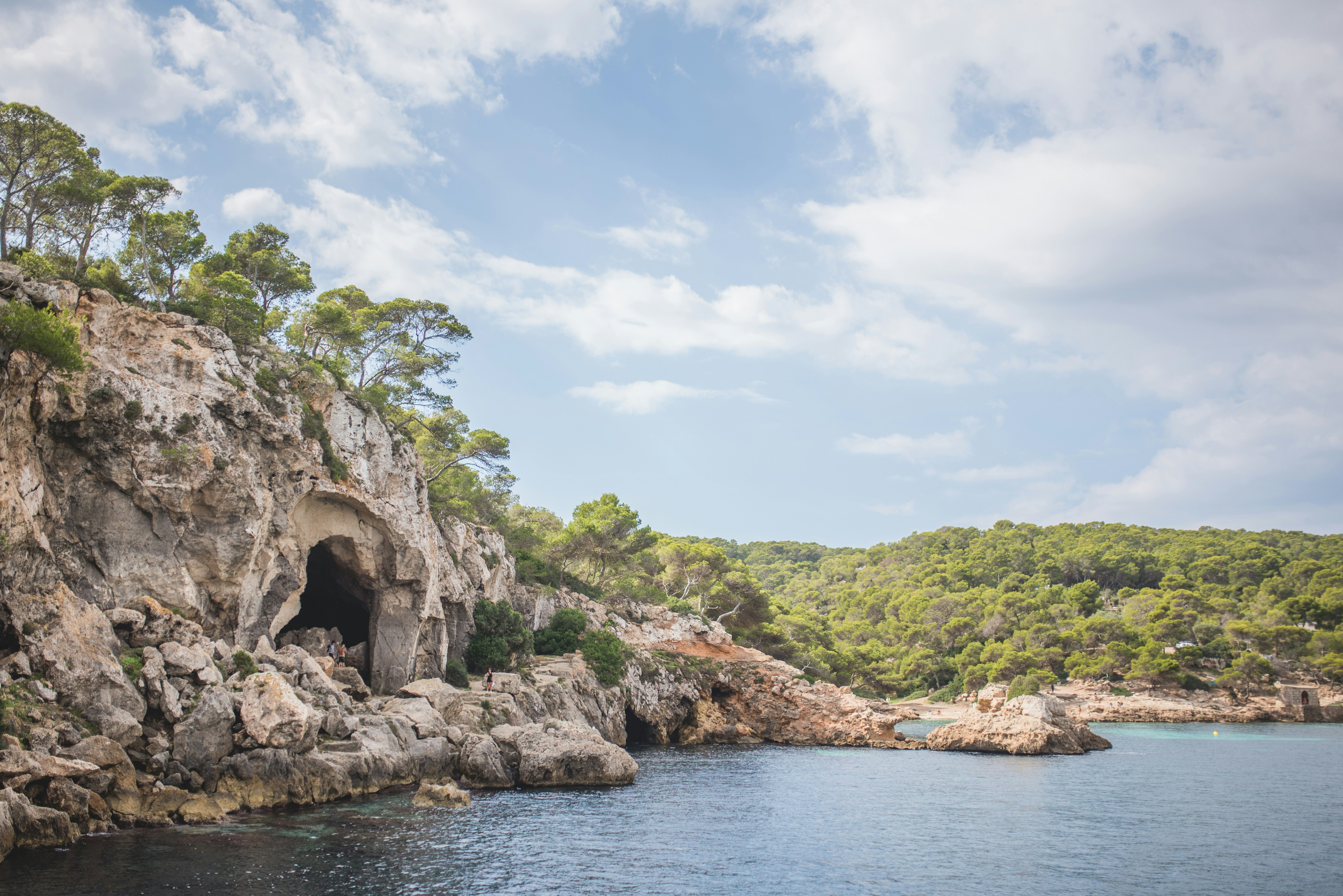a large body of water with a cave in the middle of it, 