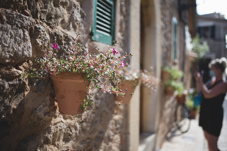 a couple of people that are walking down a street in Mallorca