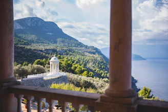 a view of a mountain and a lake from a balcony