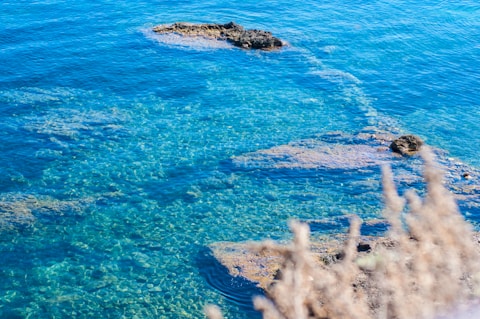 a body of water with rocks in the middle of it