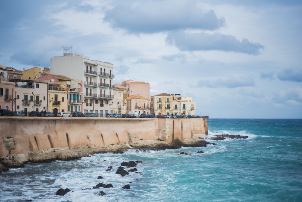 a city by the ocean with buildings on the shore