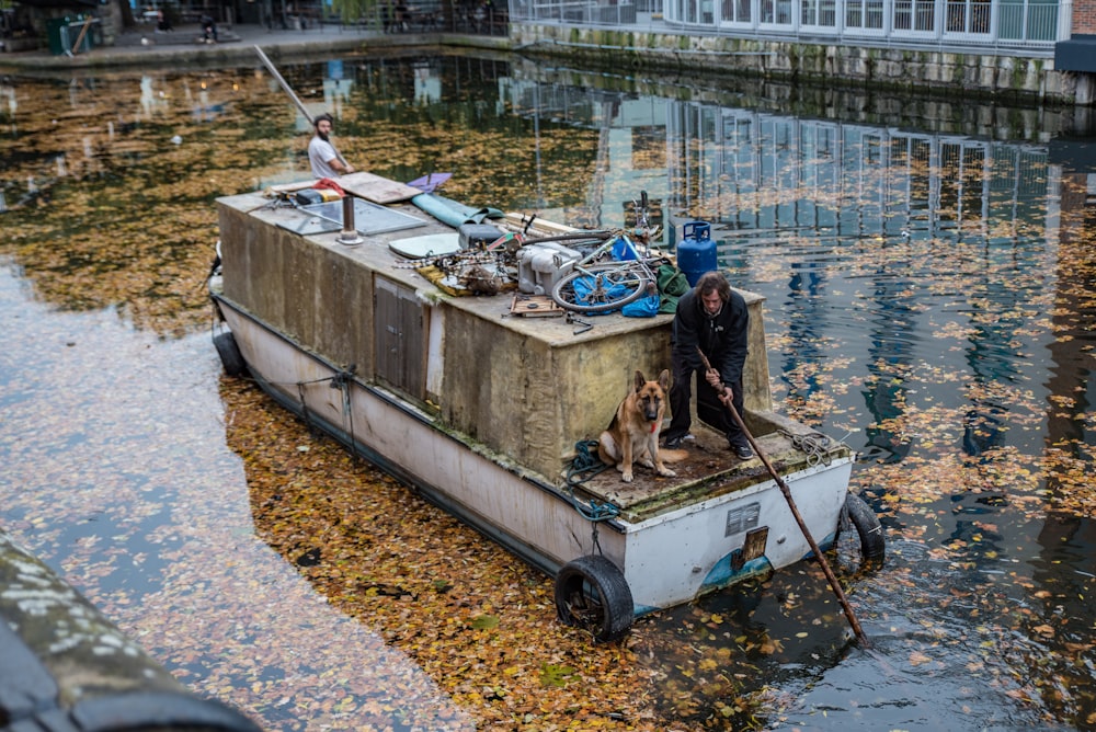 a man standing on a boat in a body of water