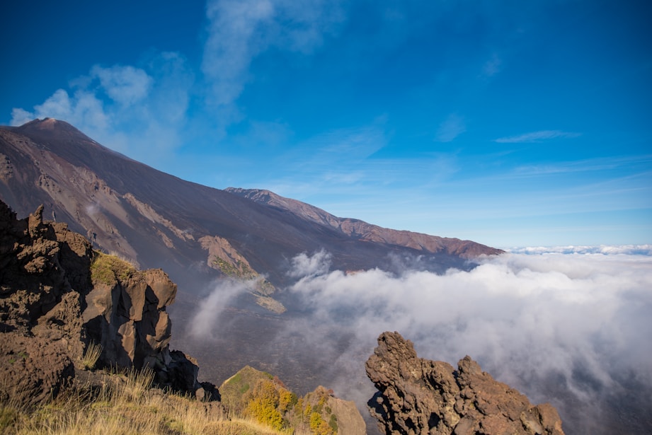 a view of the top of a mountain in the clouds