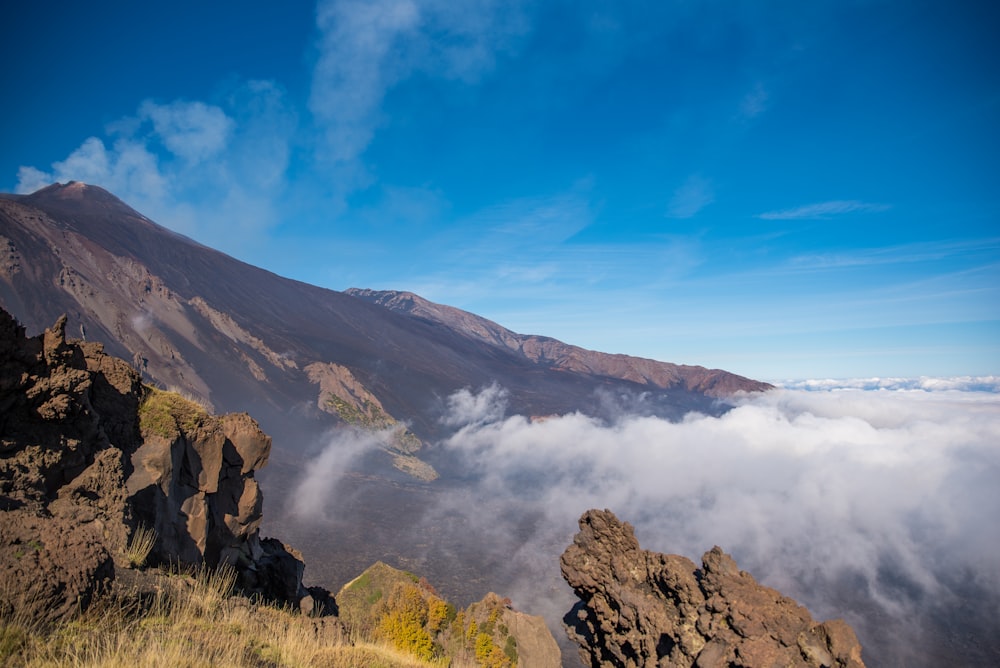 a view of the top of a mountain in the clouds