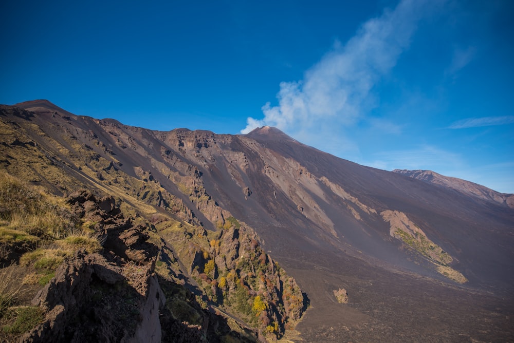 a view of a mountain with a cloud in the sky