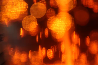 Artisan paper texture with soft burnt orange and mustard gold bokeh lights creating a warm, inviting glow.
