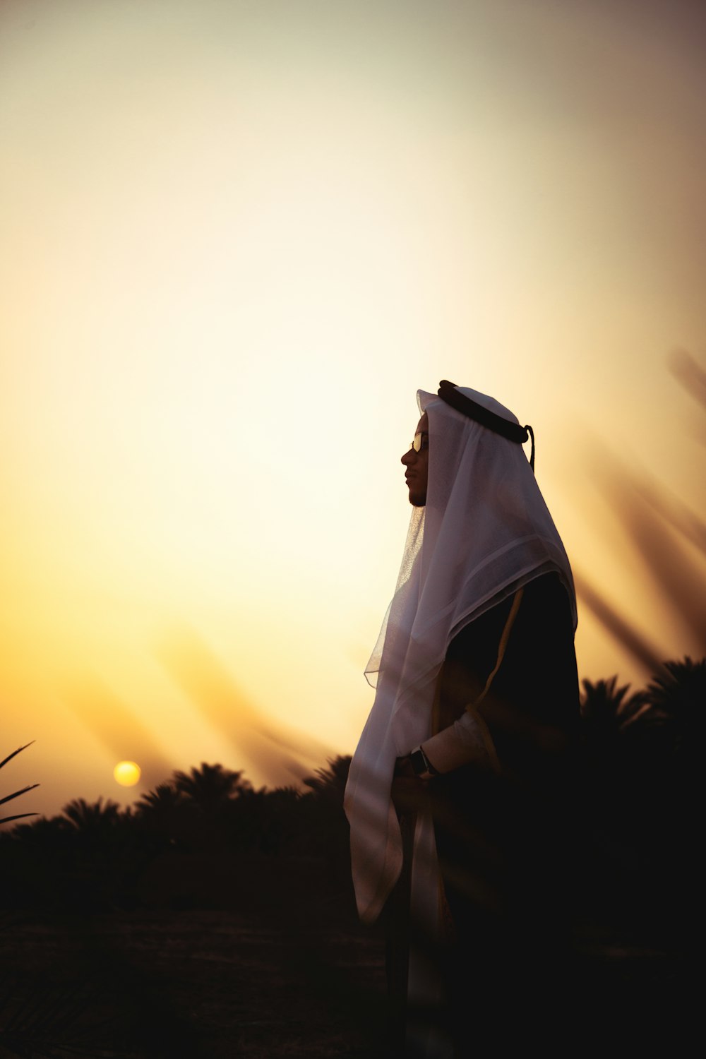 a person with a veil on standing in a field