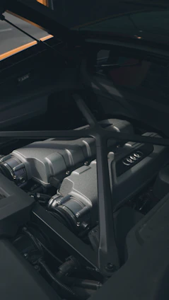 Close-up of high-end car engine parts arranged neatly on a sleek black surface
