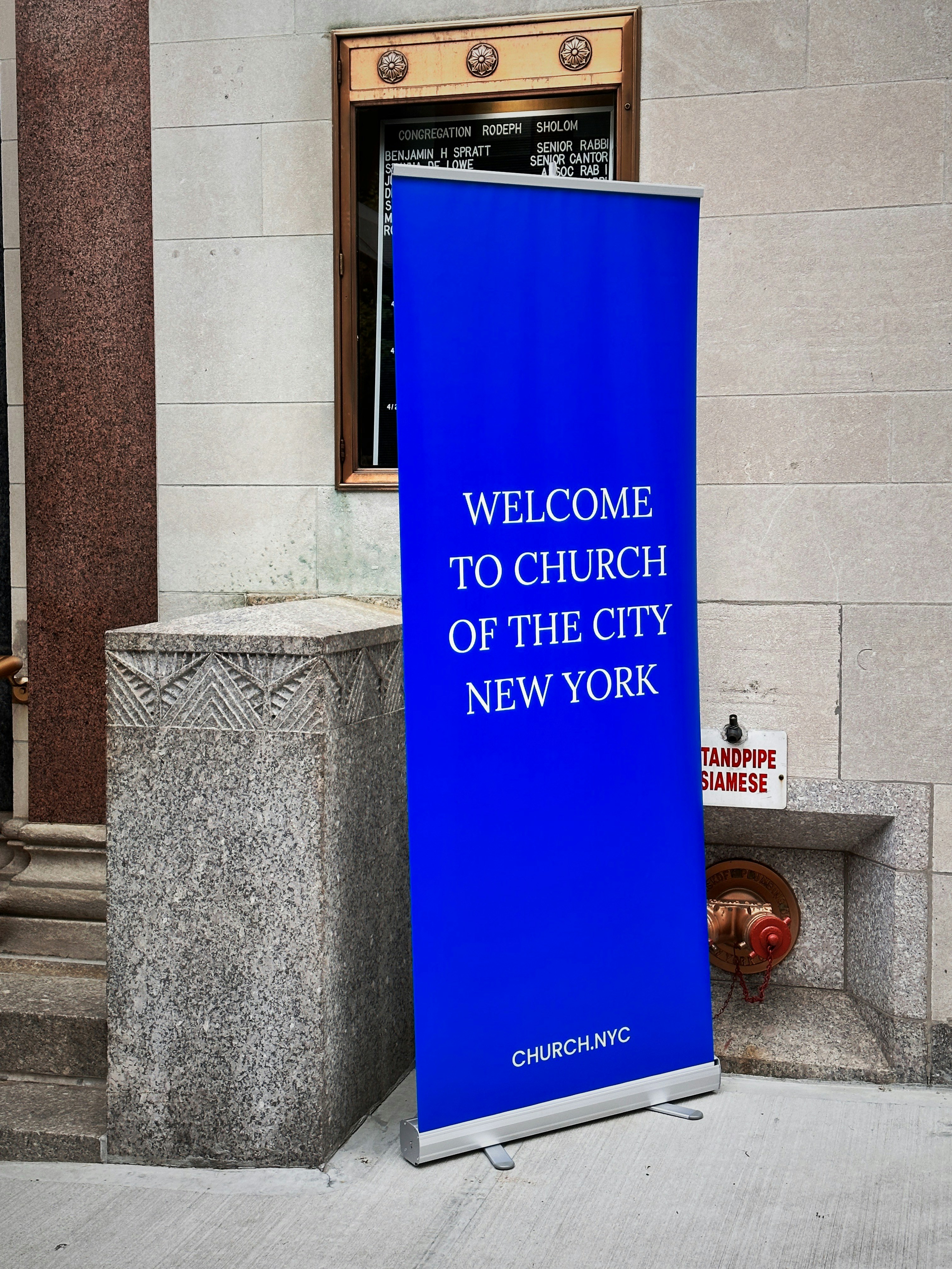 a blue sign that reads welcome to church of the city of new york