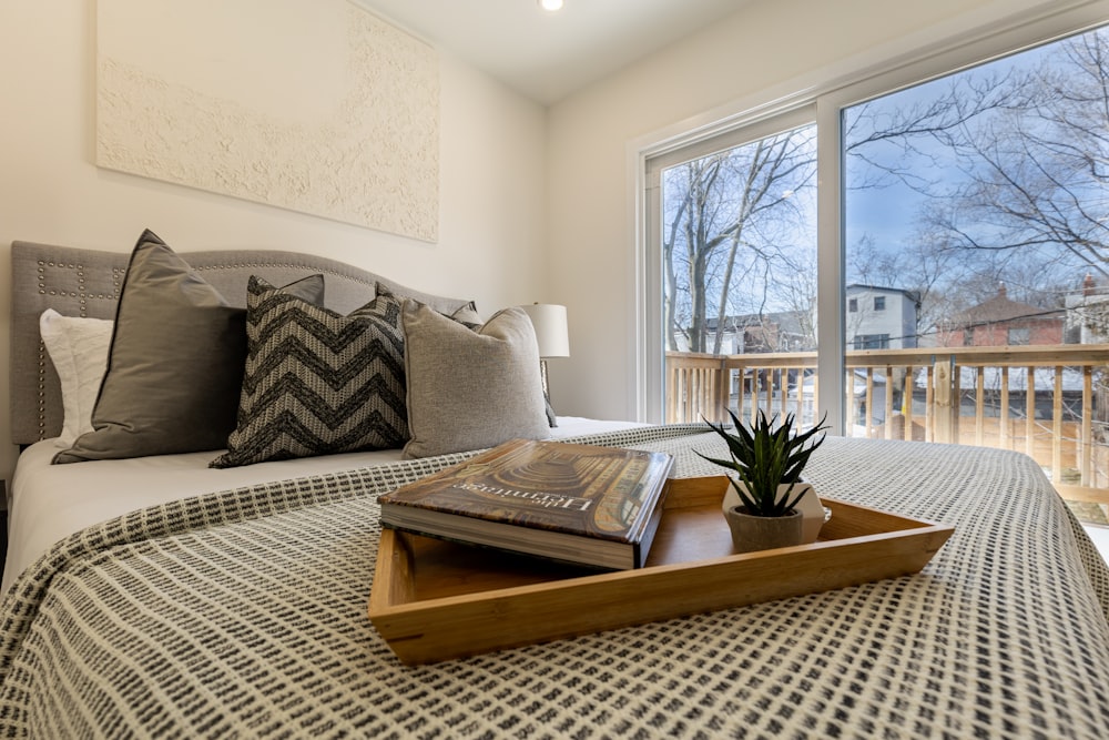 a bed with a tray of books on top of it