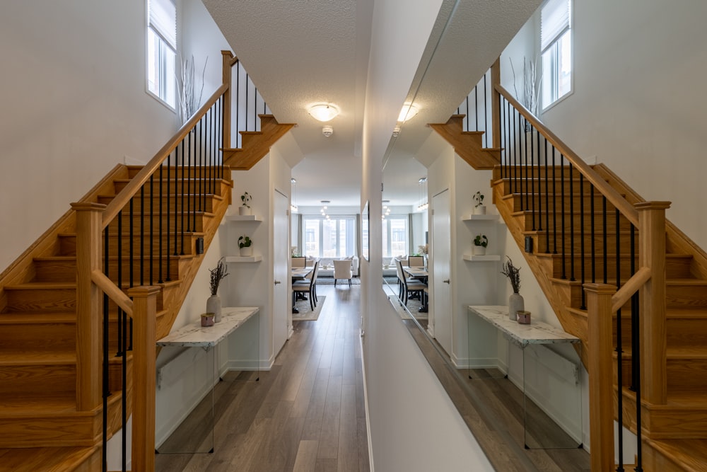 a view of a hallway with a staircase and desks