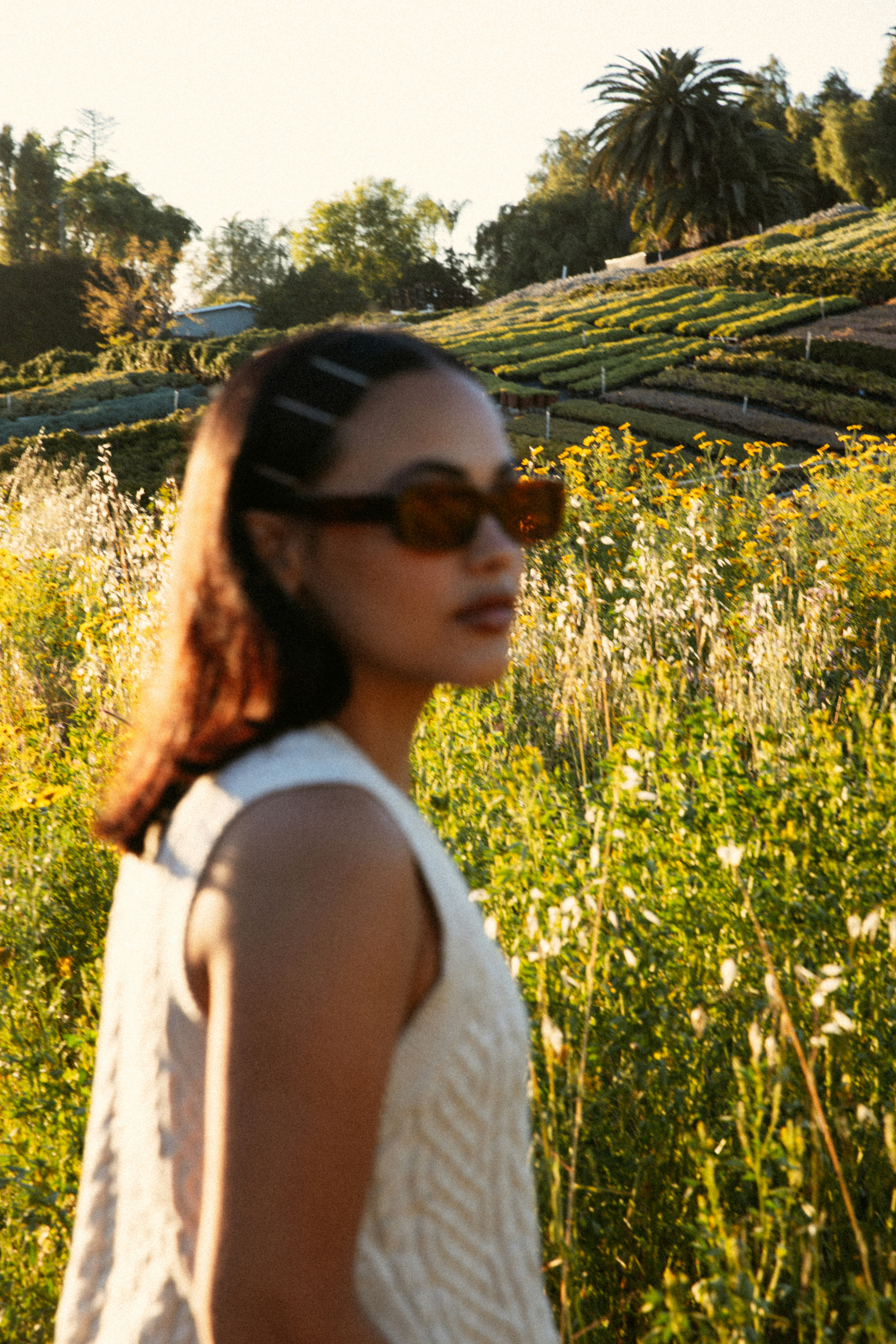 a woman standing in a field of flowers