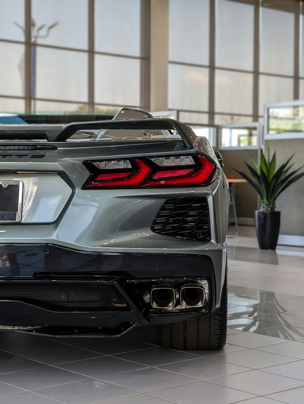 the rear end of a sports car in a showroom