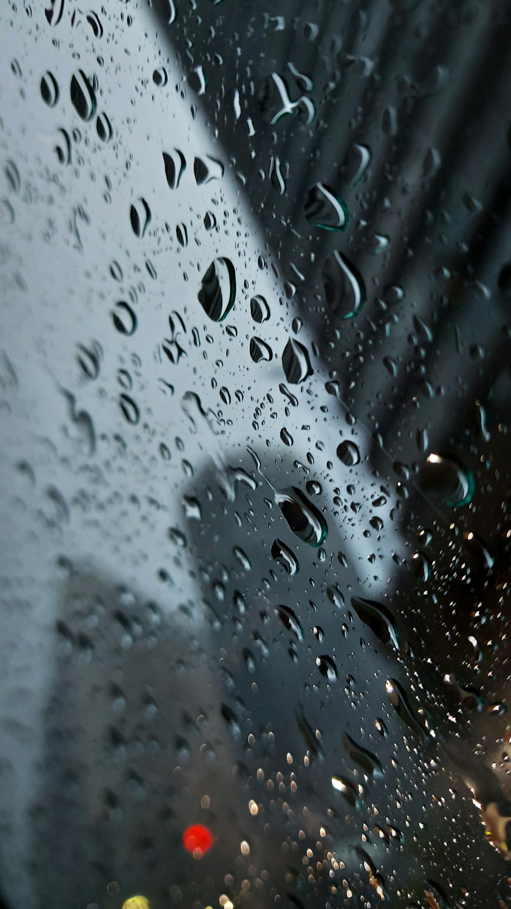 rain drops on a window with a building in the background