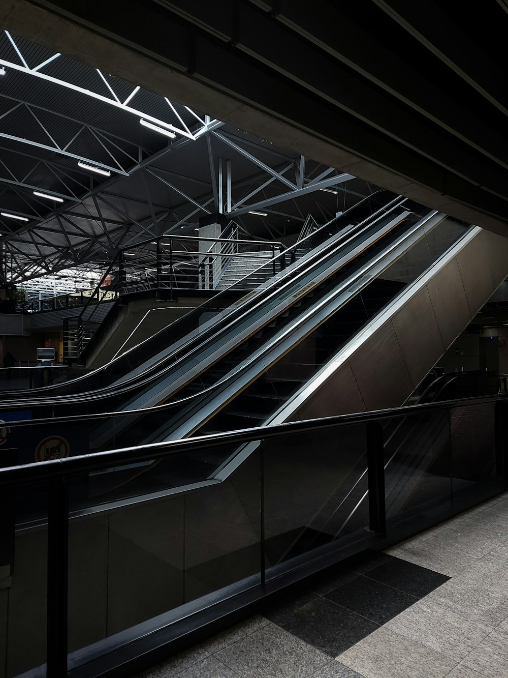 an escalator in a subway station with metal railings