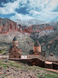 an old church in the middle of a mountain range