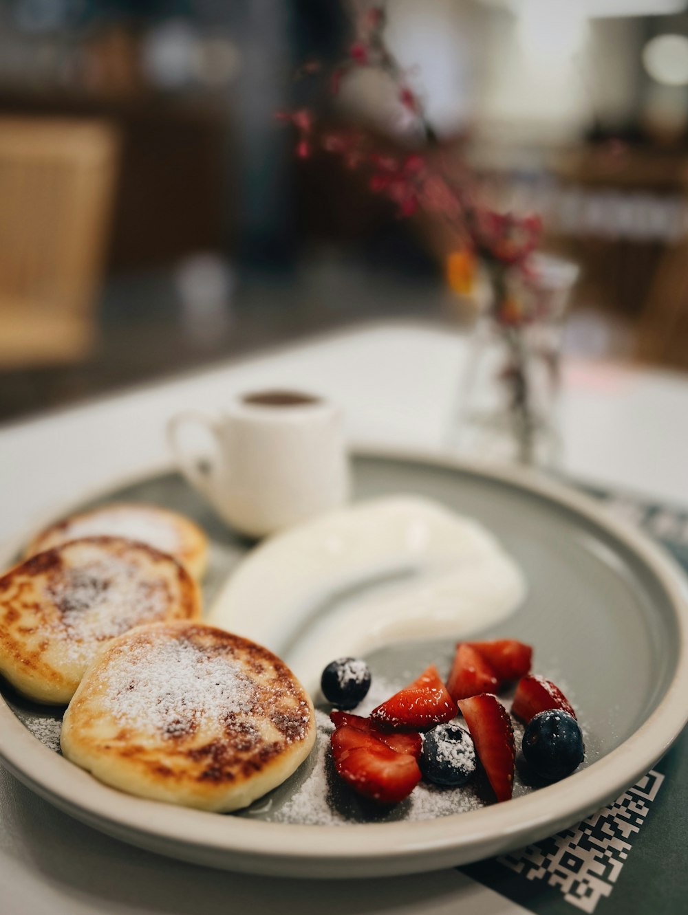 a white plate topped with pancakes and berries