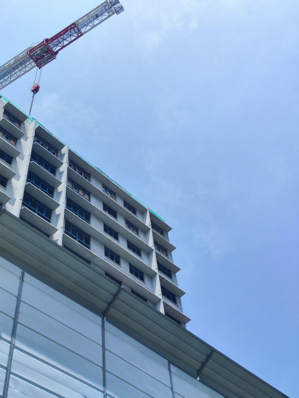 a crane is on top of a tall building