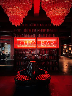 a library filled with lots of books and red lights