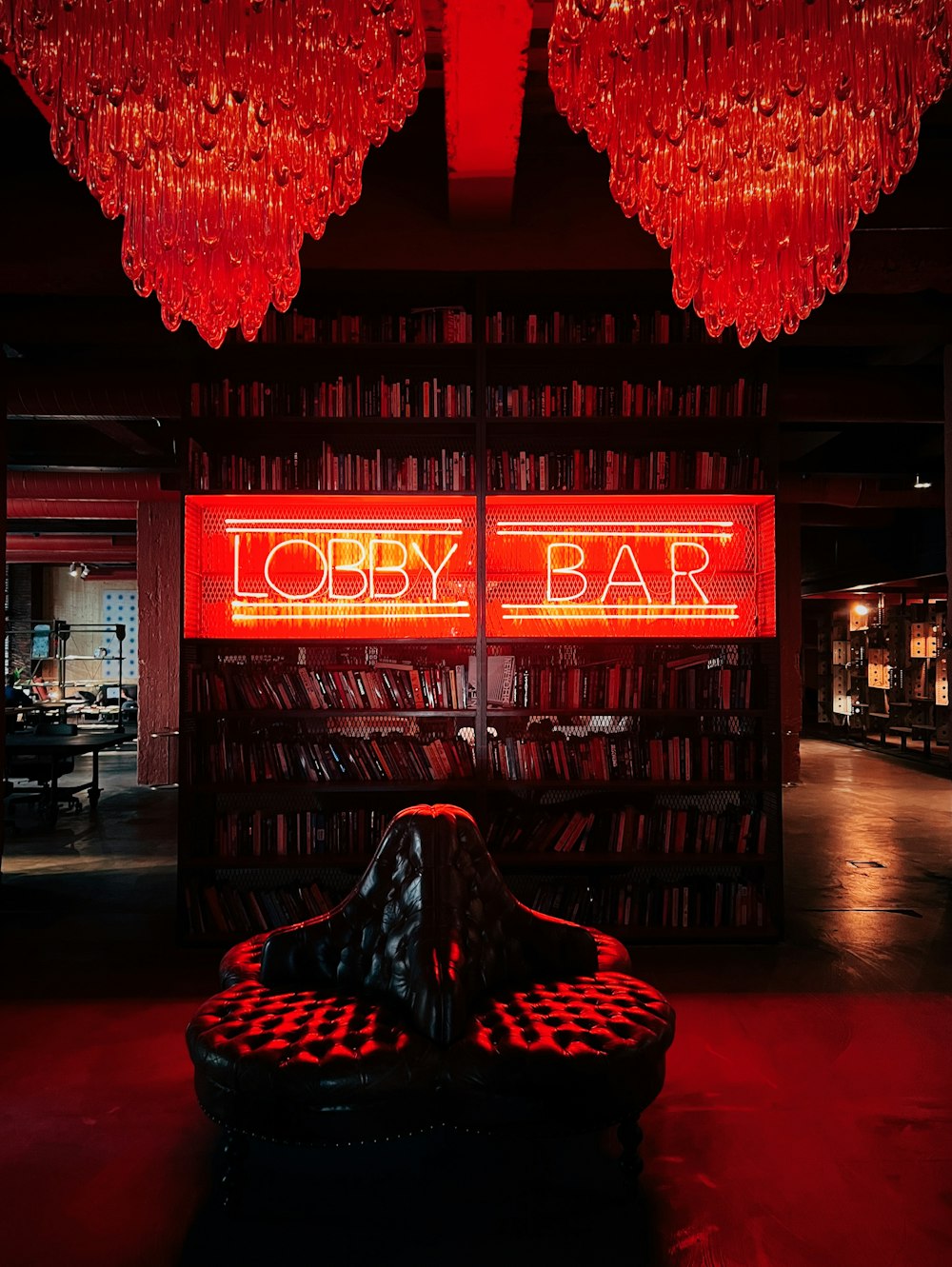 a library filled with lots of books and red lights
