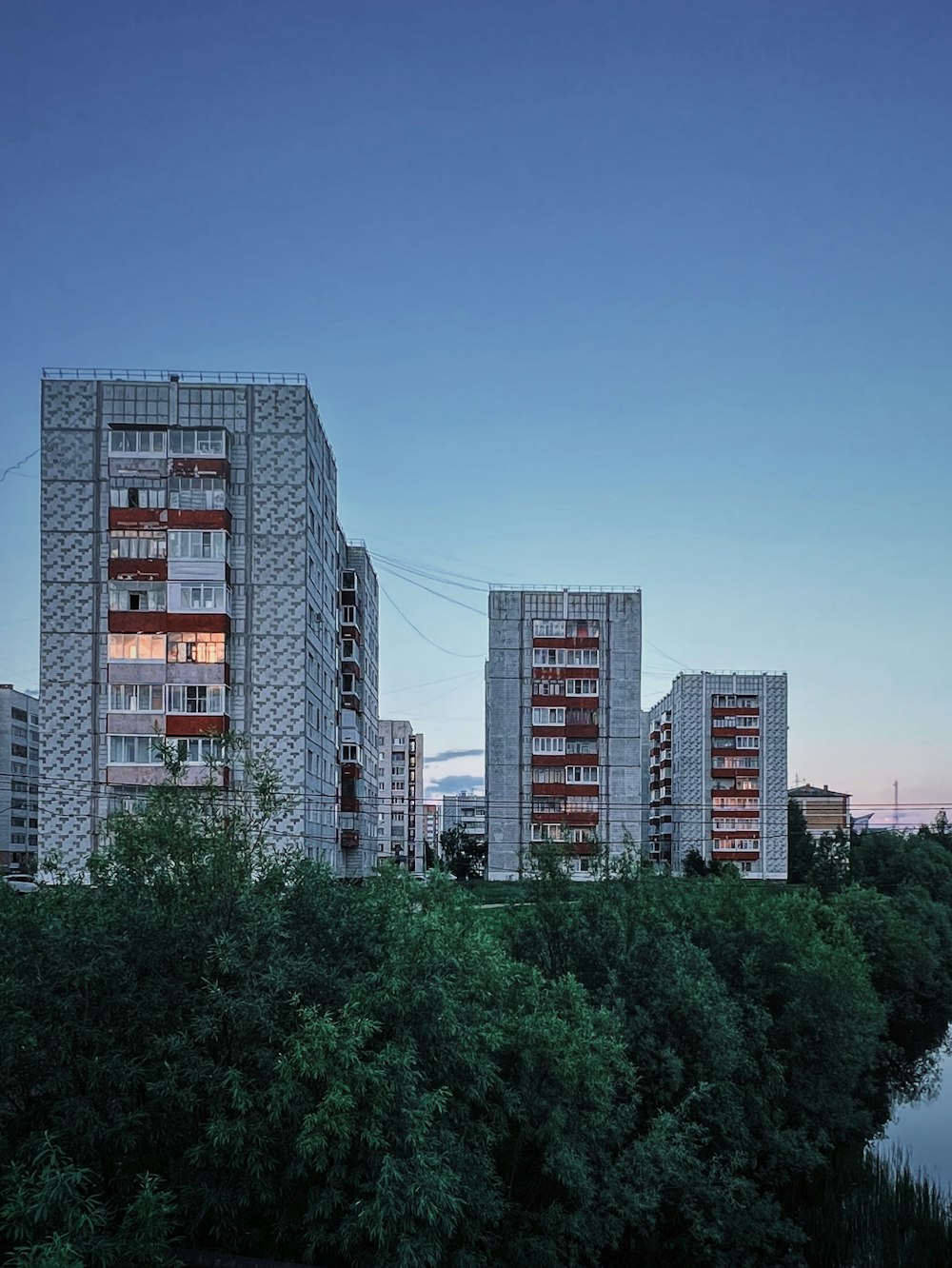 a group of tall buildings next to a river