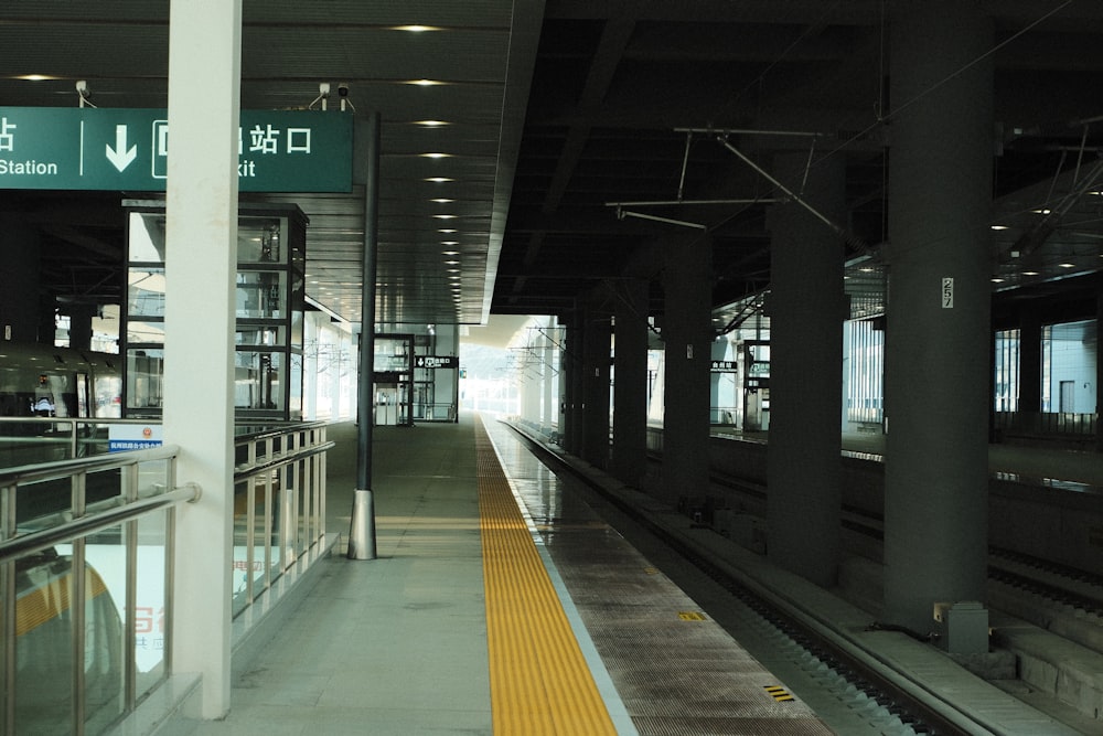 a train station with a train on the tracks