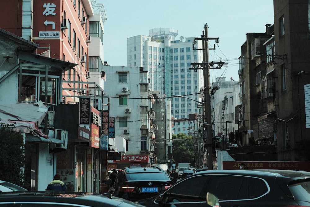 a city street filled with lots of traffic next to tall buildings