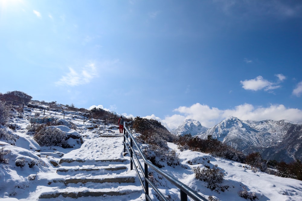a snow covered mountain with stairs leading up to the top