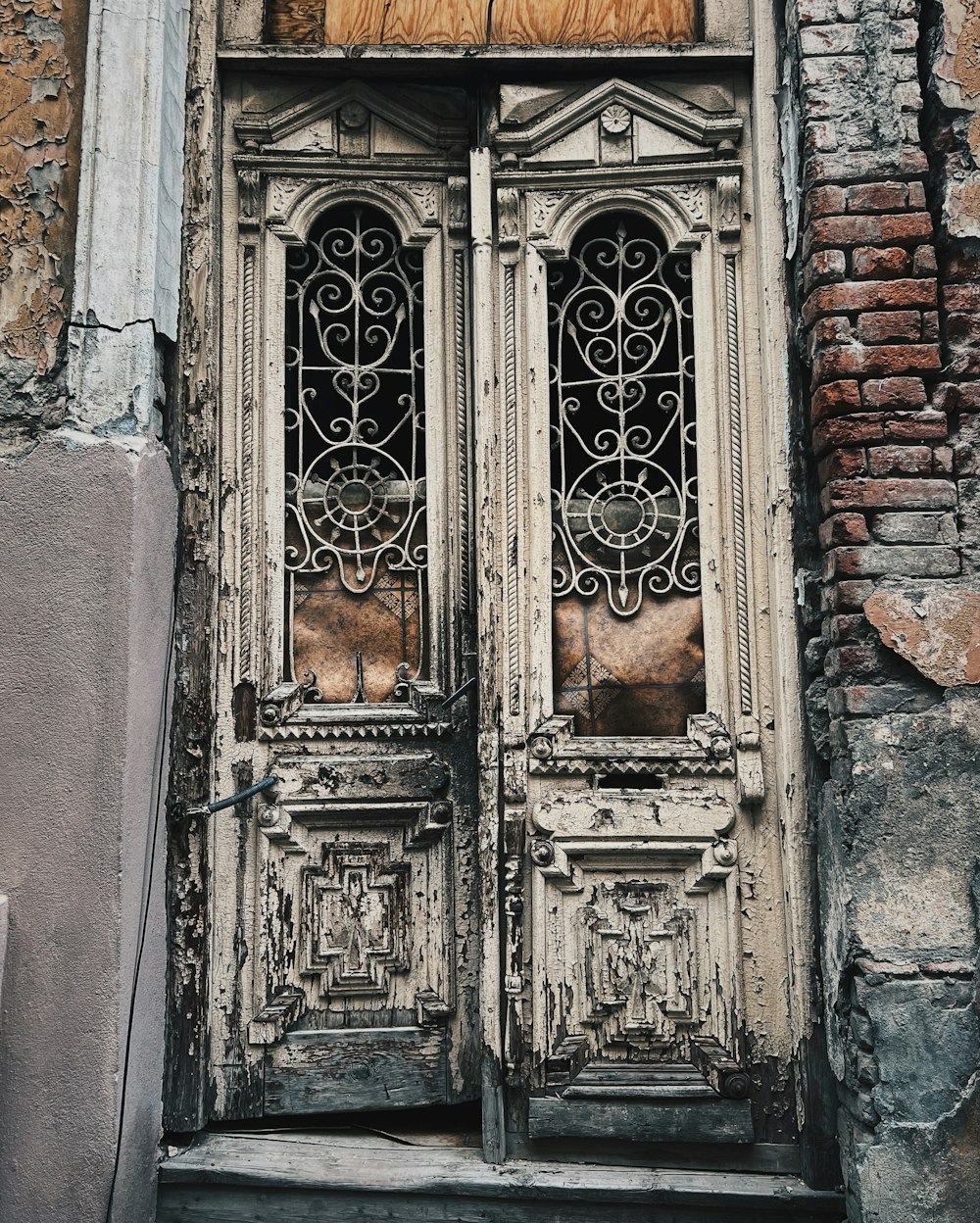 an old door with a cat sitting in the window