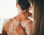 Instructor guiding a student through blouse stitching techniques.