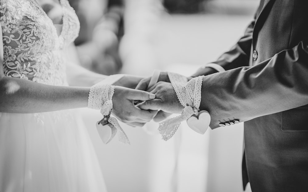 a bride and groom holding hands during a wedding ceremony