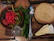 Close-up of a spoonful of vibrant achariz pickle resting over a rustic wooden table.