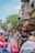 a group of people walking down a street next to tall buildings