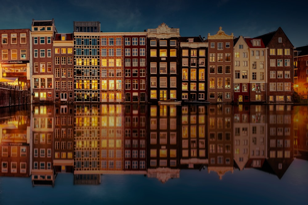 a group of buildings sitting next to a body of water