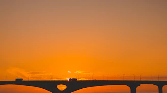 Vibrant image of the Bridge of the Americas spanning over the Panama Canal at sunset.