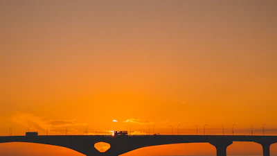 Vibrant image of the Bridge of the Americas spanning over the Panama Canal at sunset.