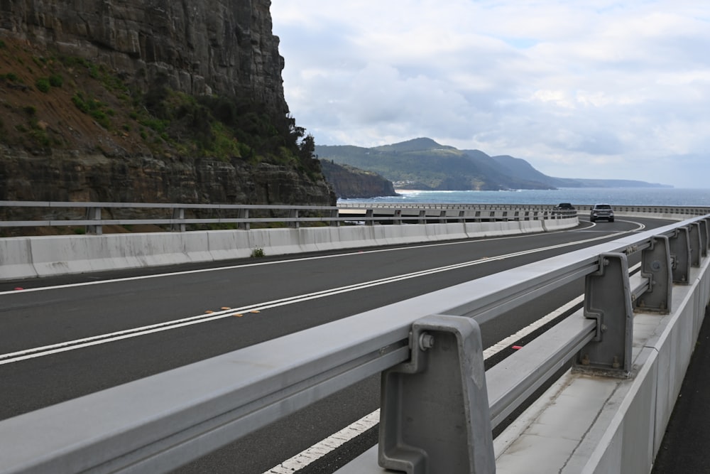 a view of a highway with a cliff in the background