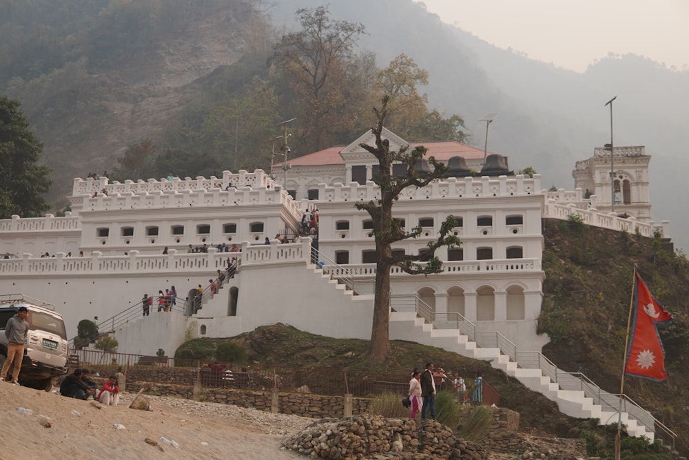 a large white building sitting on top of a hill