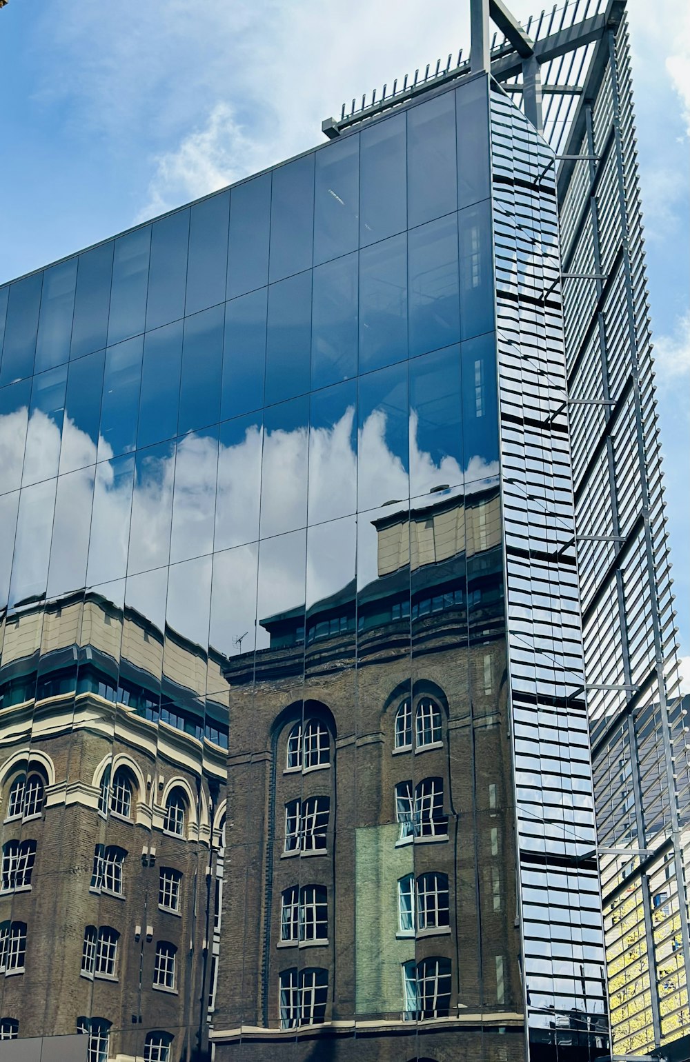 a reflection of a building in the glass of another building