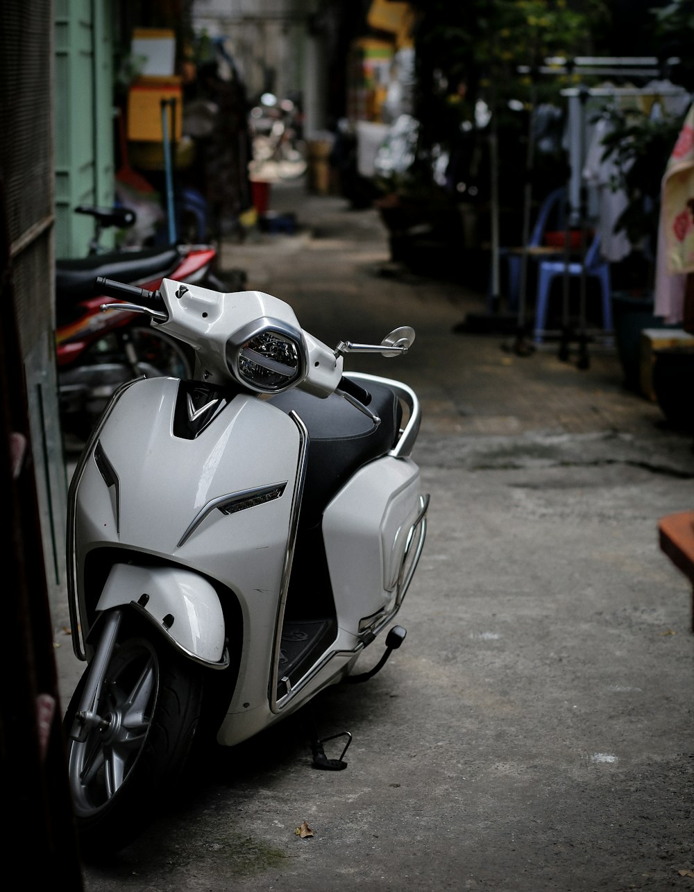 a white and black motorcycle parked next to a building