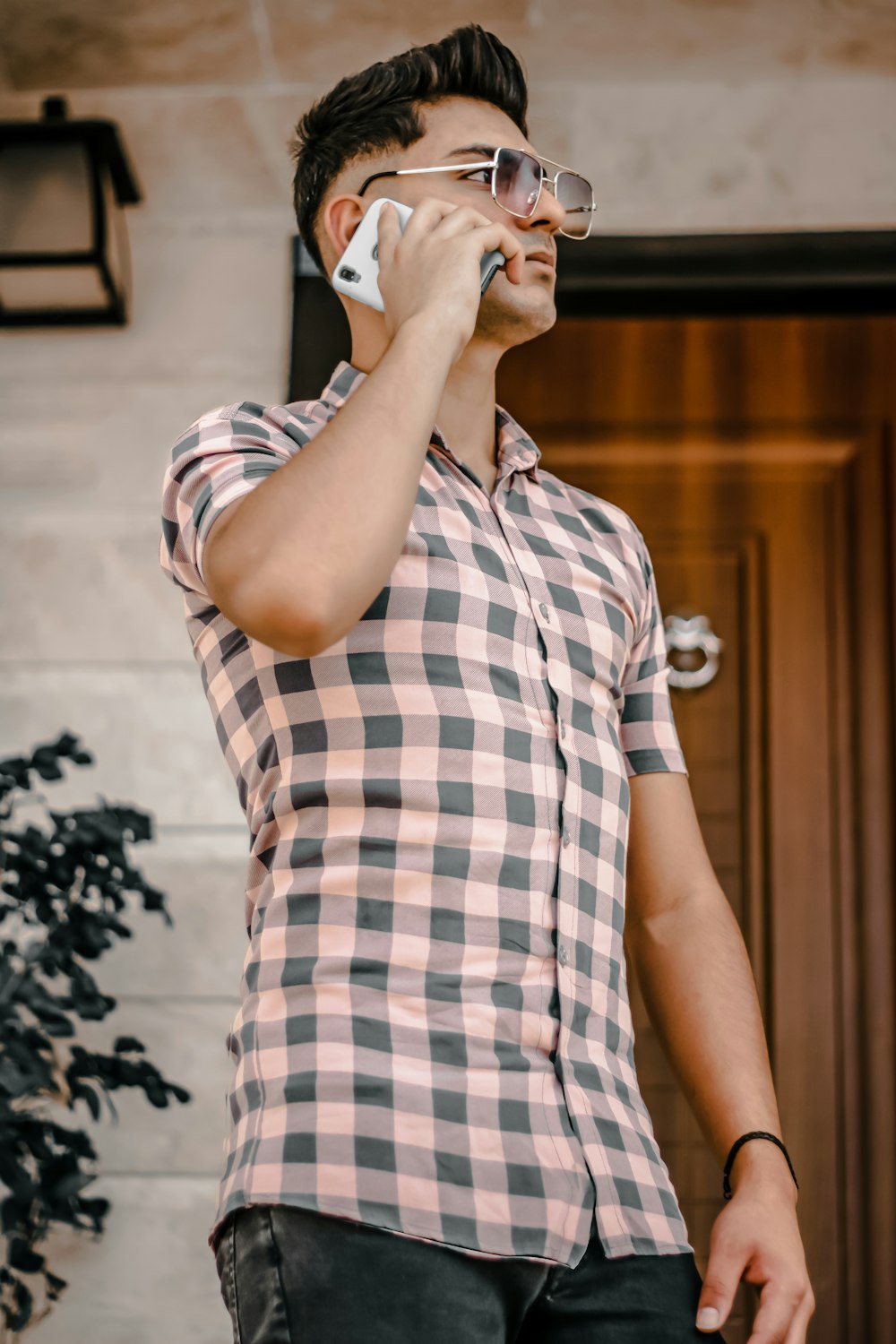 a man wearing glasses talking on a cell phone