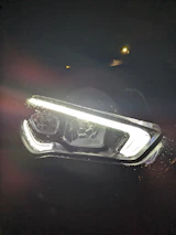 An image of a bright, clear car headlight next to a faded one for comparison.