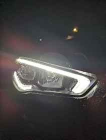 Before-and-after side-by-side of a headlight restored from cloudy to crystal clear.