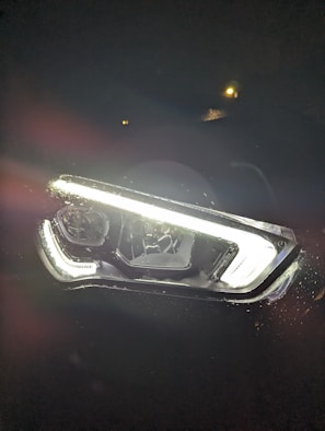 Before and after comparison of a foggy headlight restored to clear condition.