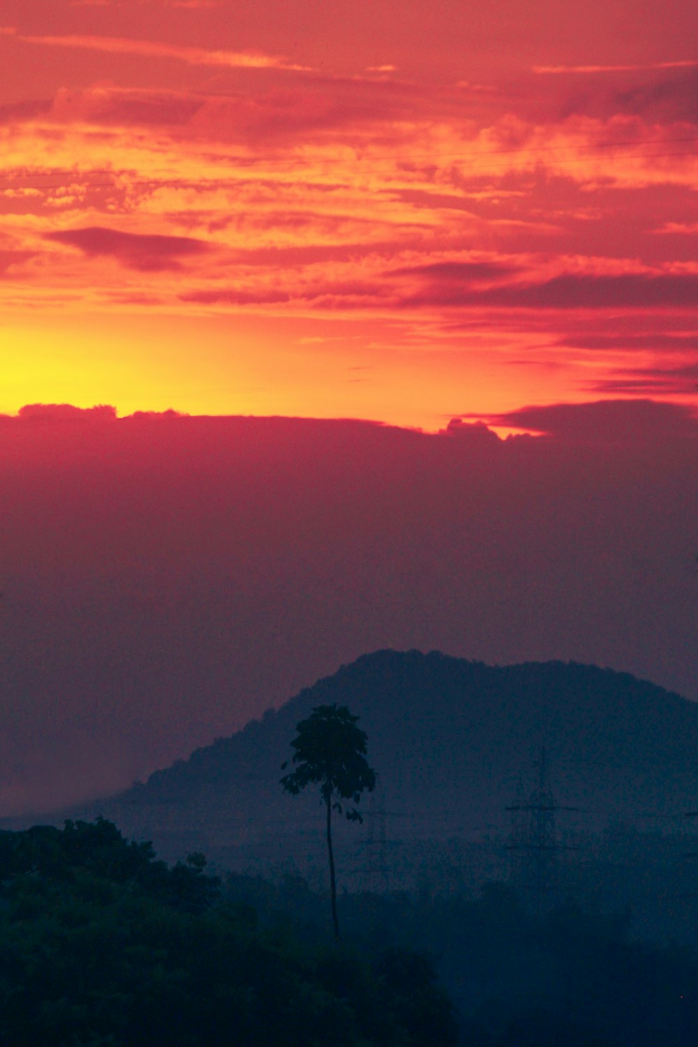 the sun is setting over a mountain range