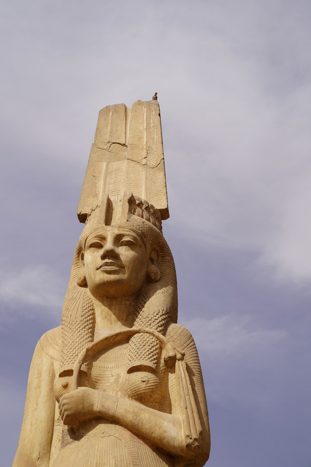 a large statue of a woman holding a bird