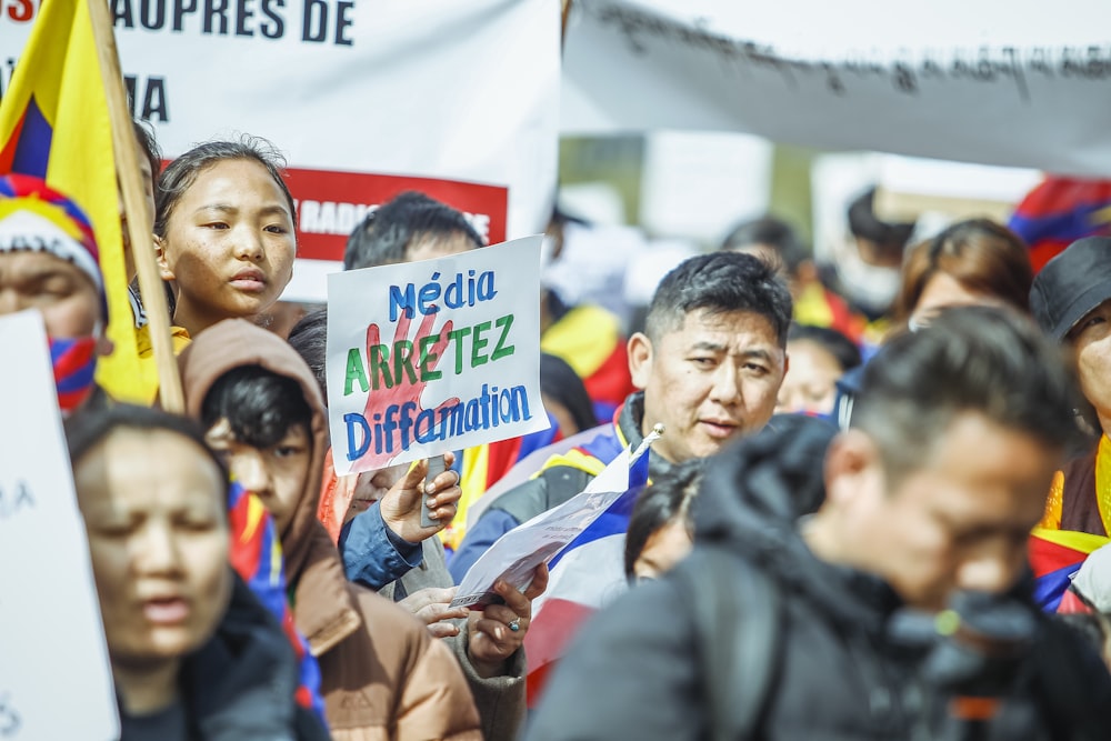 a large group of people holding signs and flags